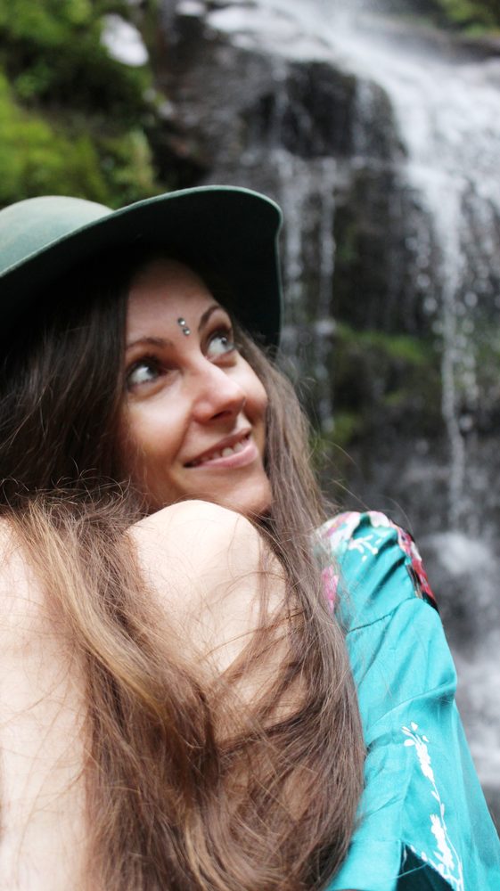 Michela smiling by a waterfall